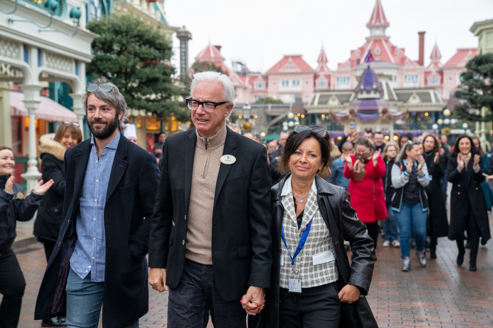 A visually emotional Daniel Delcourt is welcomed by Cast Members on Main Street.